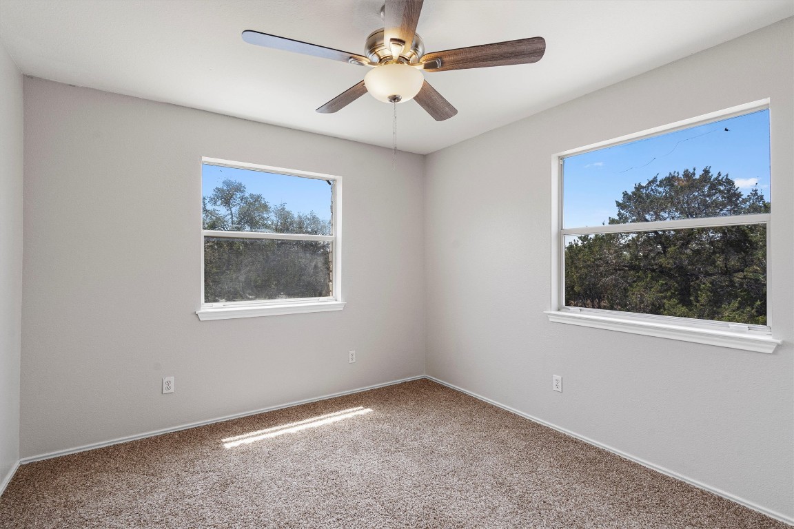 25600 Ronald Reagan Boulevard Georgetown, TX 78633 - Photo 31 of 36 an empty room with a window and a ceiling fan