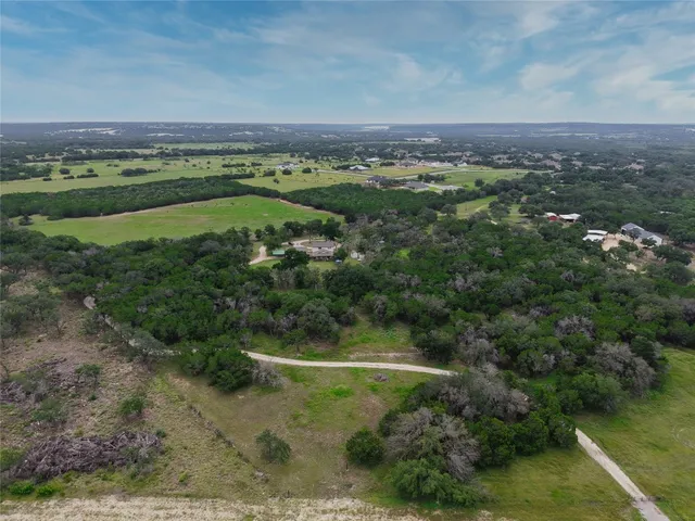 a view of a green field with lots of bushes