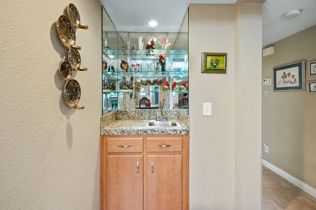 a kitchen with stainless steel appliances granite countertop a sink and a refrigerator