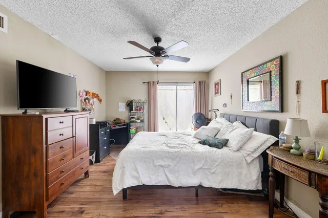 a bedroom with a bed and a flat screen tv