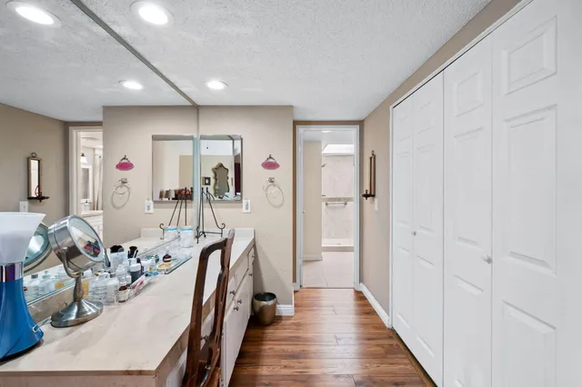 a hallway with wooden floor and furniture