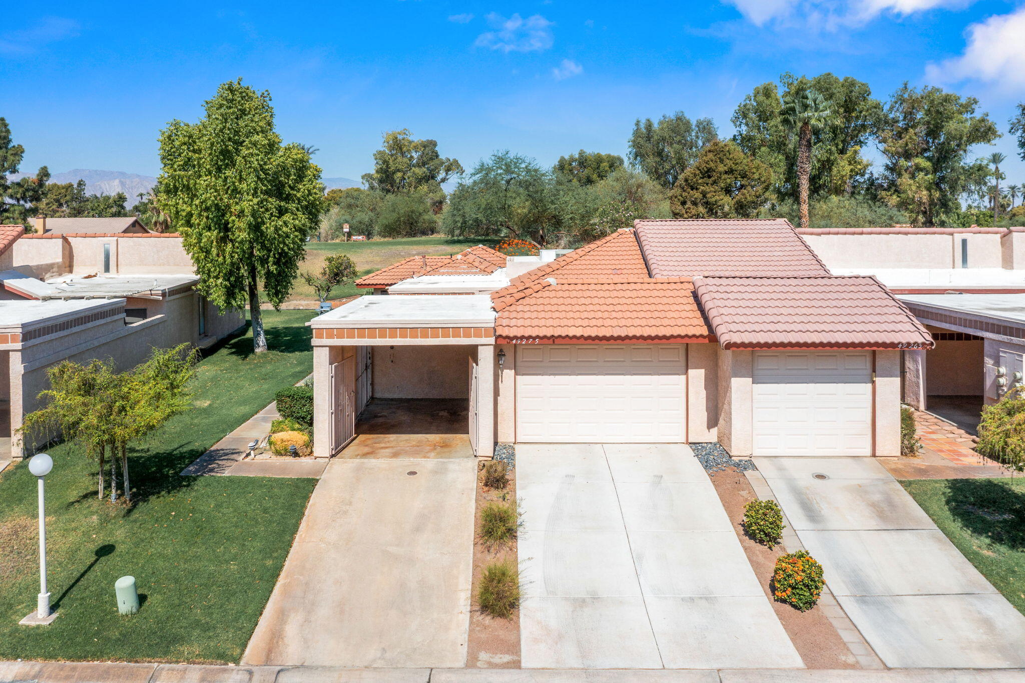 49275 Douglas Street Indio, CA 92201 - Photo 24 of 37 a view of a patio with table and chairs with wooden floor and fence