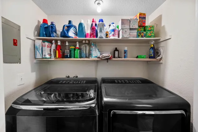 a view of a house with a big yard and potted plants