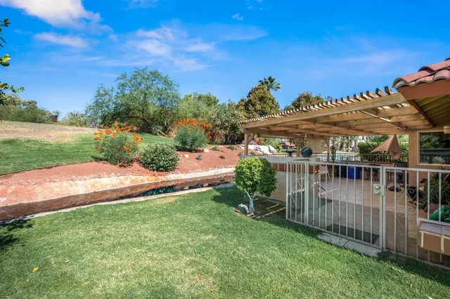 a view of a house with a backyard and a deck