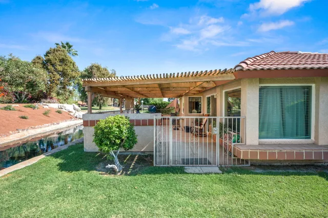 a view of a porch with furniture and backyard
