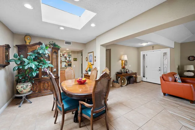 a living room with furniture and a dining table