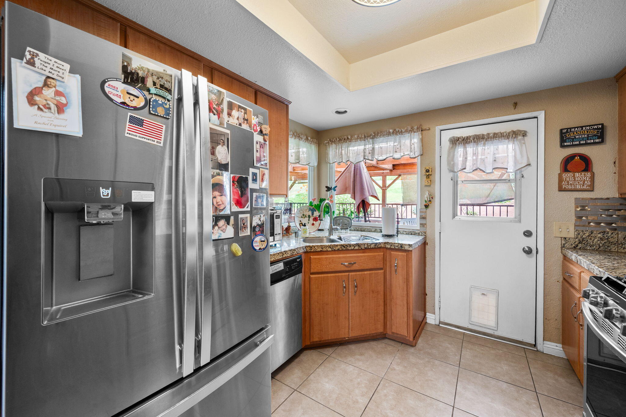 49275 Douglas Street Indio, CA 92201 - Photo 10 of 37 a kitchen with stainless steel appliances granite countertop a refrigerator and a sink