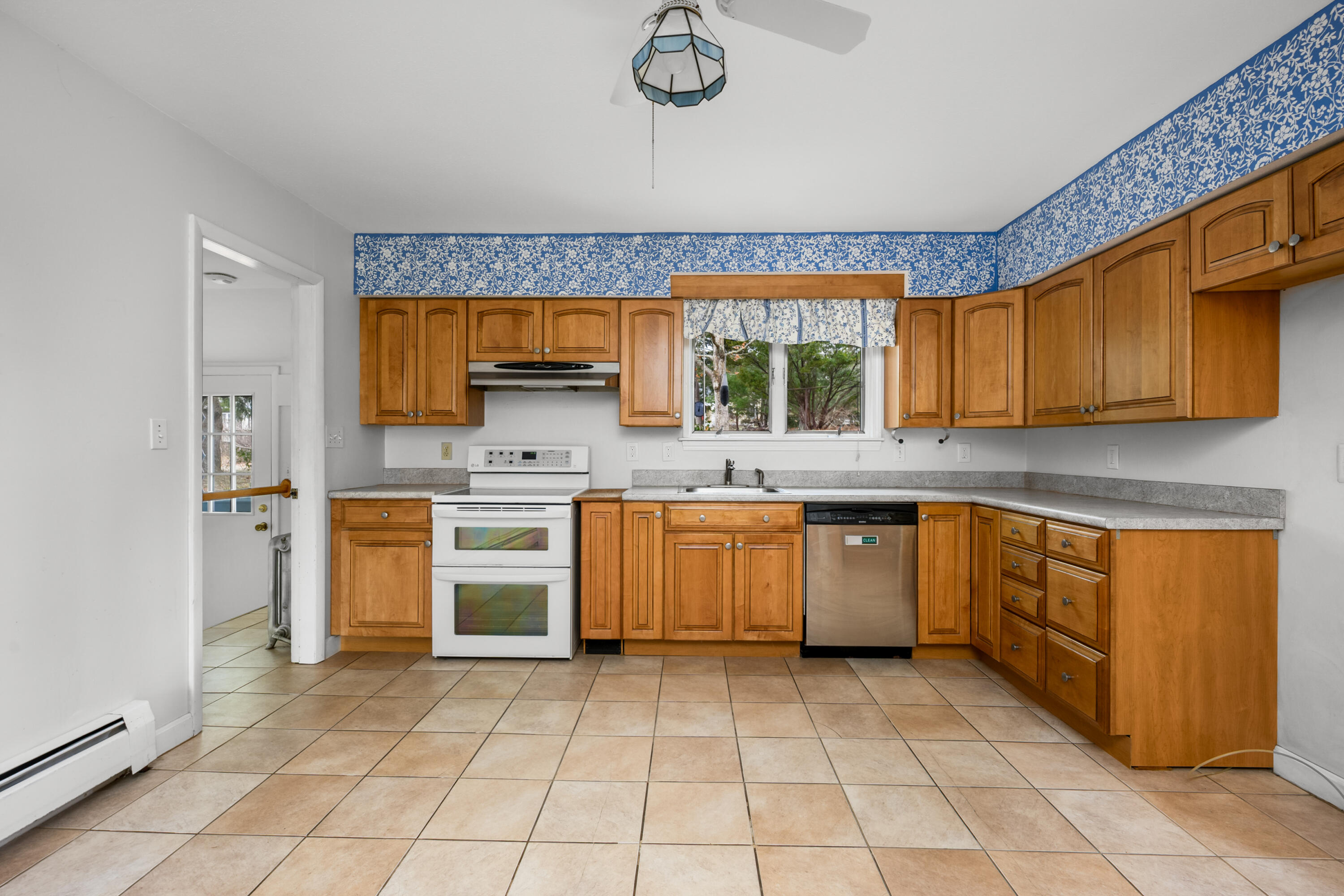 33 Head Of The Bay Road Buzzards Bay, MA 02532 - Photo 12 of 46 a kitchen with a stove sink and cabinets