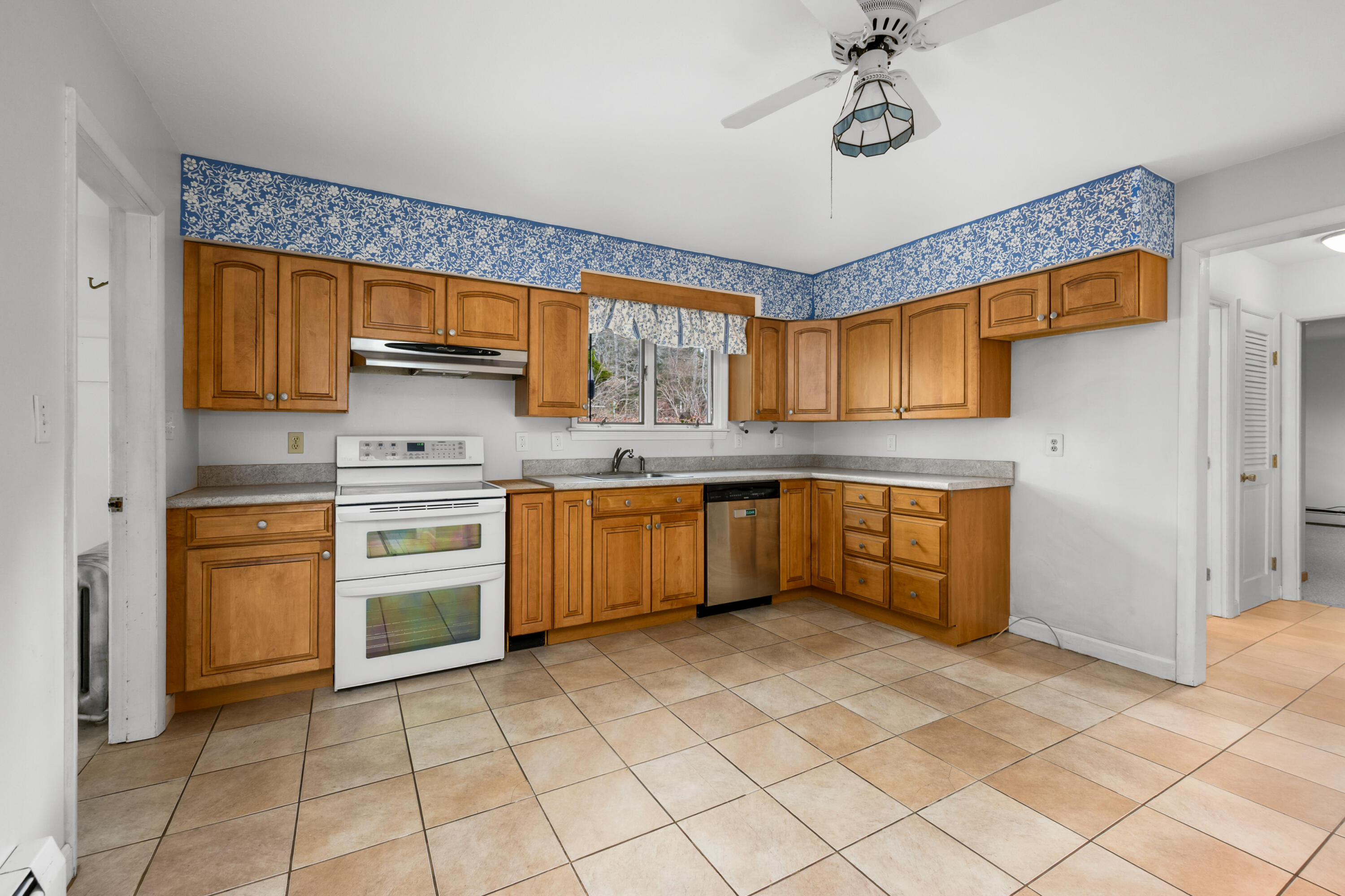 33 Head Of The Bay Road Buzzards Bay, MA 02532 - Photo 13 of 46 a kitchen with stainless steel appliances a sink and a refrigerator