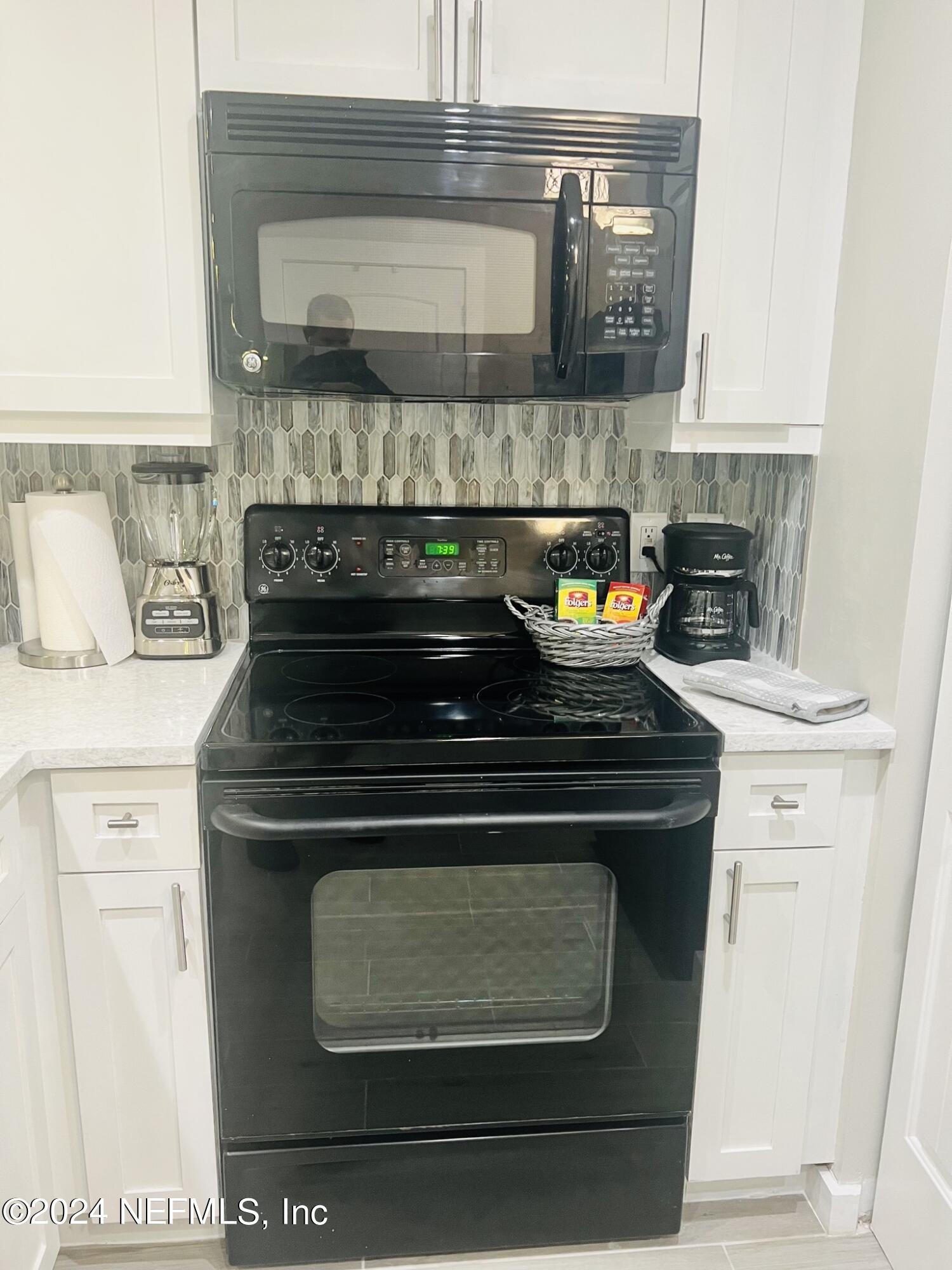 955 Registry Boulevard, Unit 210 St. Augustine, FL 32092 - Photo 14 of 31 a stove top oven sitting inside of a kitchen