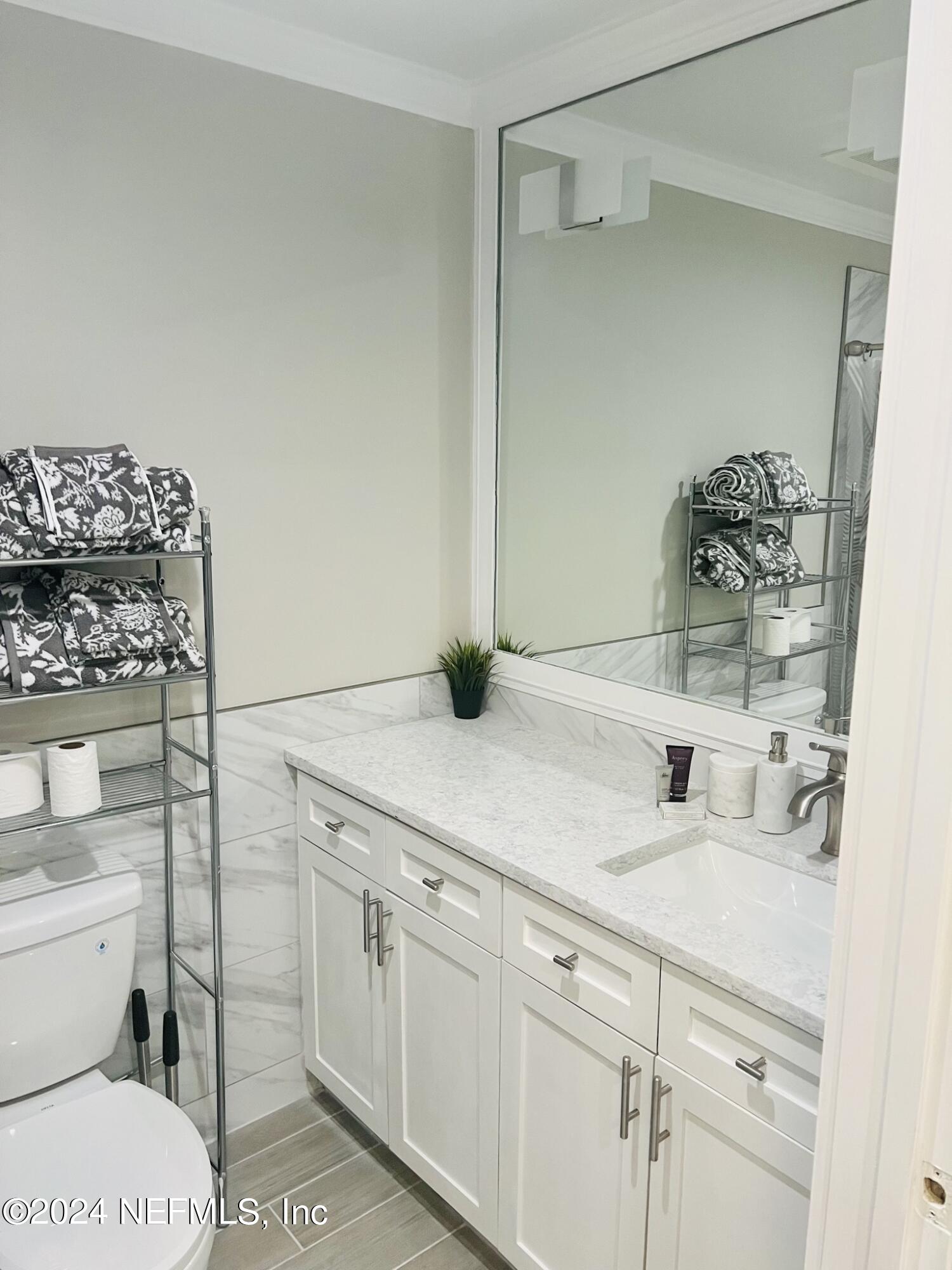955 Registry Boulevard, Unit 210 St. Augustine, FL 32092 - Photo 21 of 31 a bathroom with a sink a toilet and shower