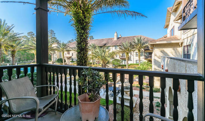 955 Registry Boulevard, Unit 210 St. Augustine, FL 32092 - Photo 7 of 31 a view of a balcony with chair and table