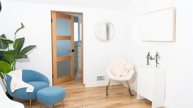 a living room with furniture a window and a potted plant
