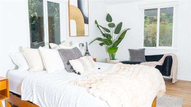 a bedroom with a bed and a large window