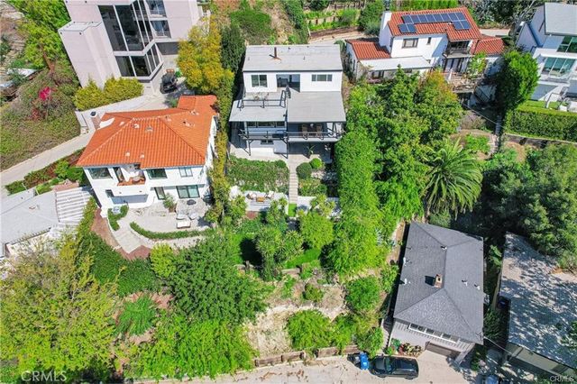 an aerial view of residential houses with outdoor space and street view