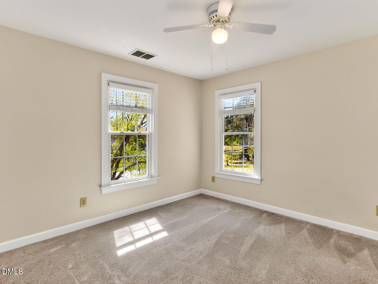 6104 Wolverhampton Drive Raleigh, NC 27603 - Photo 17 of 35 an empty room with windows and fan