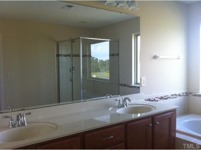 4139 Davis Meadow Street Raleigh, NC 27616 - Photo 12 of 25 Owner's Bath Retreat with garden tub and enclosed shower with tile surround and private water closet.