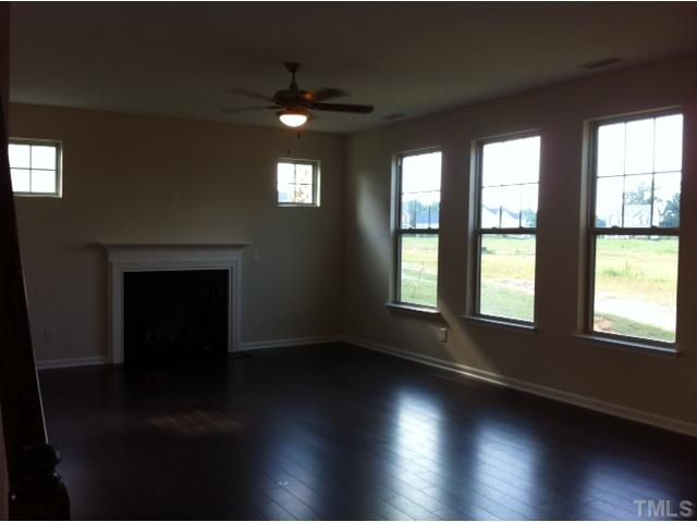 4139 Davis Meadow Street Raleigh, NC 27616 - Photo 10 of 25 Open Family Room with Fireplace and 5 inch plank hardwoods.