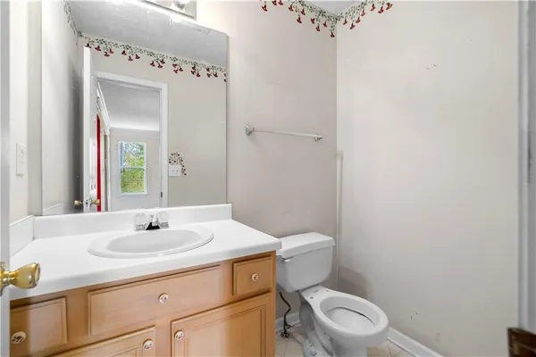 a bathroom with a sink a toilet and mirror