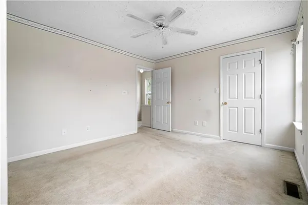a view of an empty room with a ceiling fan