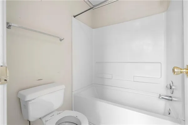 a bathroom with a toilet and a bathtub