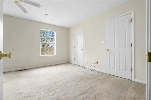 an empty room with wall painting and windows