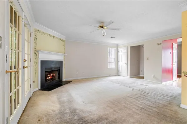 a view of a livingroom with a fireplace and window