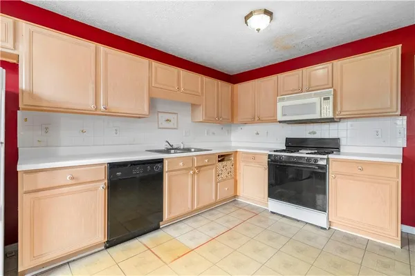 a kitchen with stainless steel appliances granite countertop a sink and cabinets