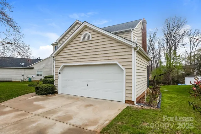 a view of a house with a yard and garage