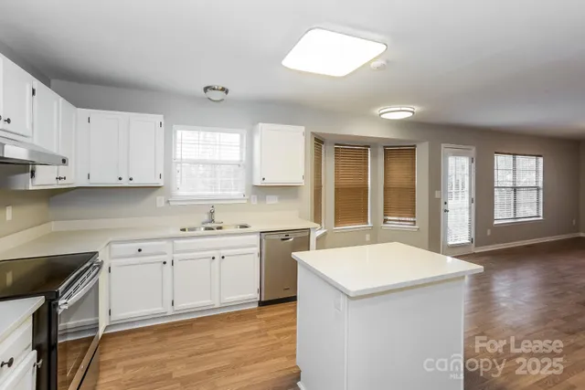 a kitchen with a sink stove and cabinets