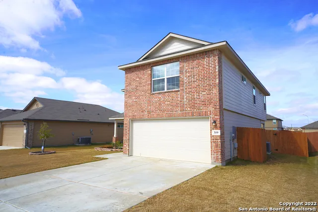 a view of an house with backyard space and garage