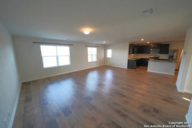 a view of a kitchen with a sink and a window