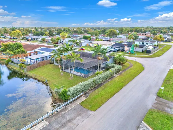 an aerial view of residential houses with outdoor space and swimming pool