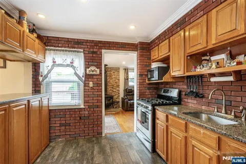 a kitchen with stainless steel appliances granite countertop a stove and a sink