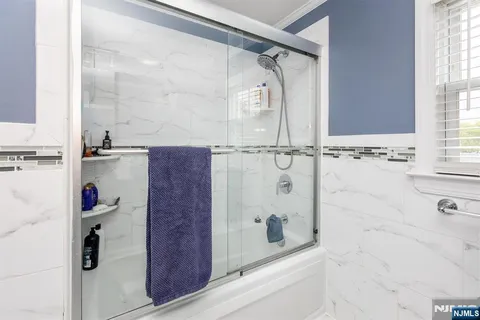 a bathroom with a bathtub and shower