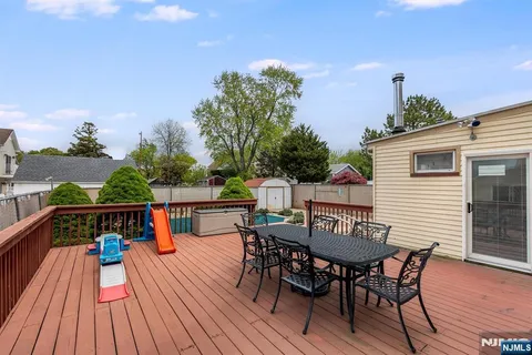 a view of deck with table and chairs and wooden floor