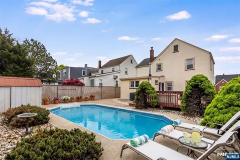 a view of a backyard with plants and patio