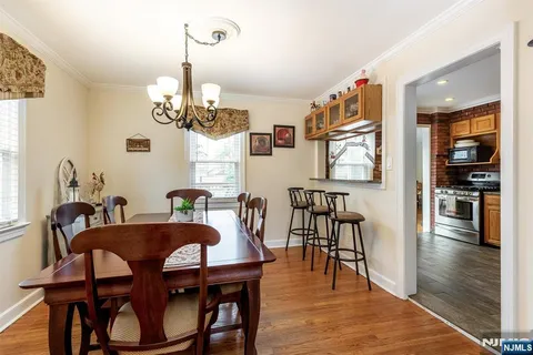 a view of a dining room with furniture wooden floor and chandelier