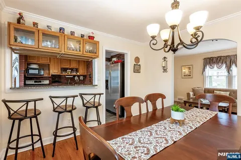 a view of a dining room with furniture and chandelier