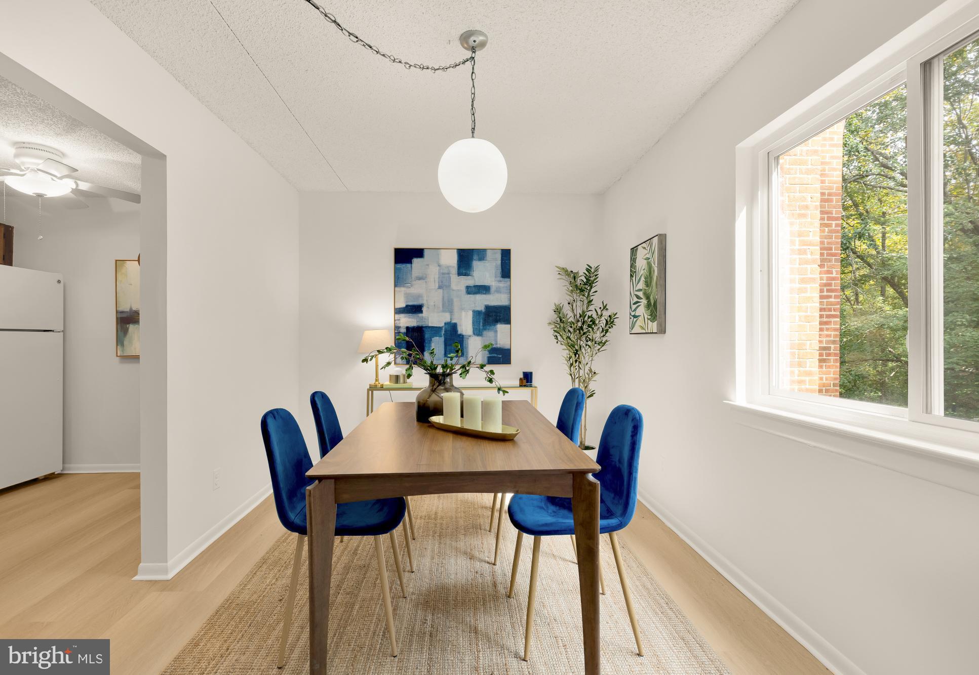 11833 Shire Court, Unit 21B Reston, VA 20191 - Photo 11 of 37 a view of a dining room with furniture and a large window