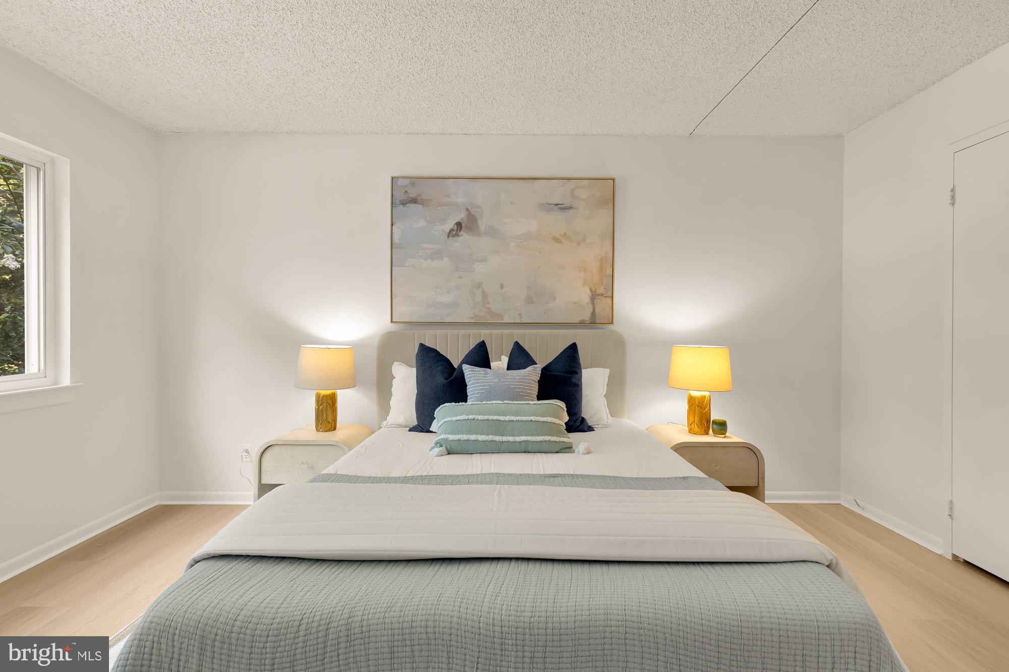 11833 Shire Court, Unit 21B Reston, VA 20191 - Photo 20 of 37 a bedroom with a bed and lamps