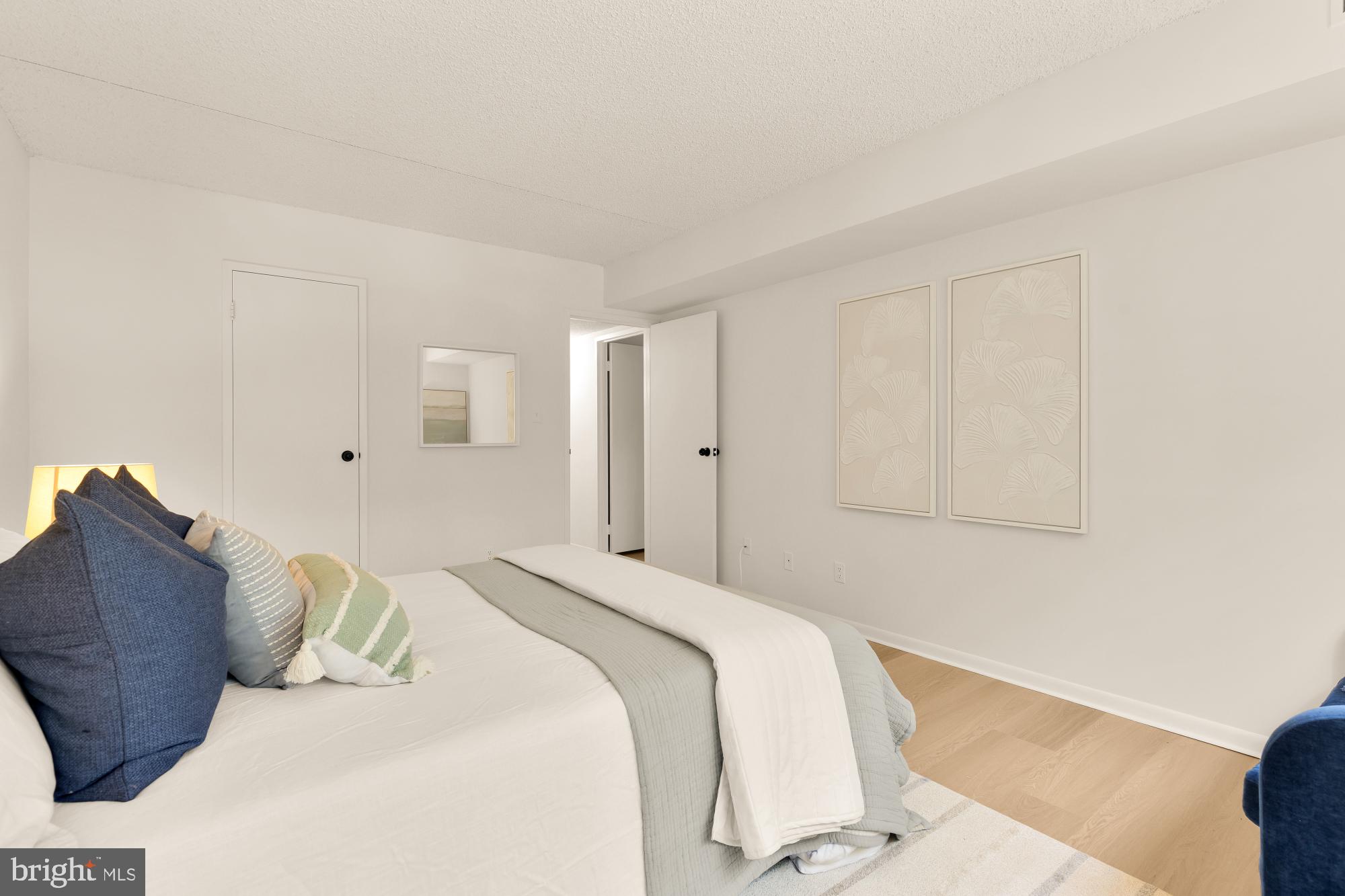 11833 Shire Court, Unit 21B Reston, VA 20191 - Photo 21 of 37 a bedroom with a bed and a couch