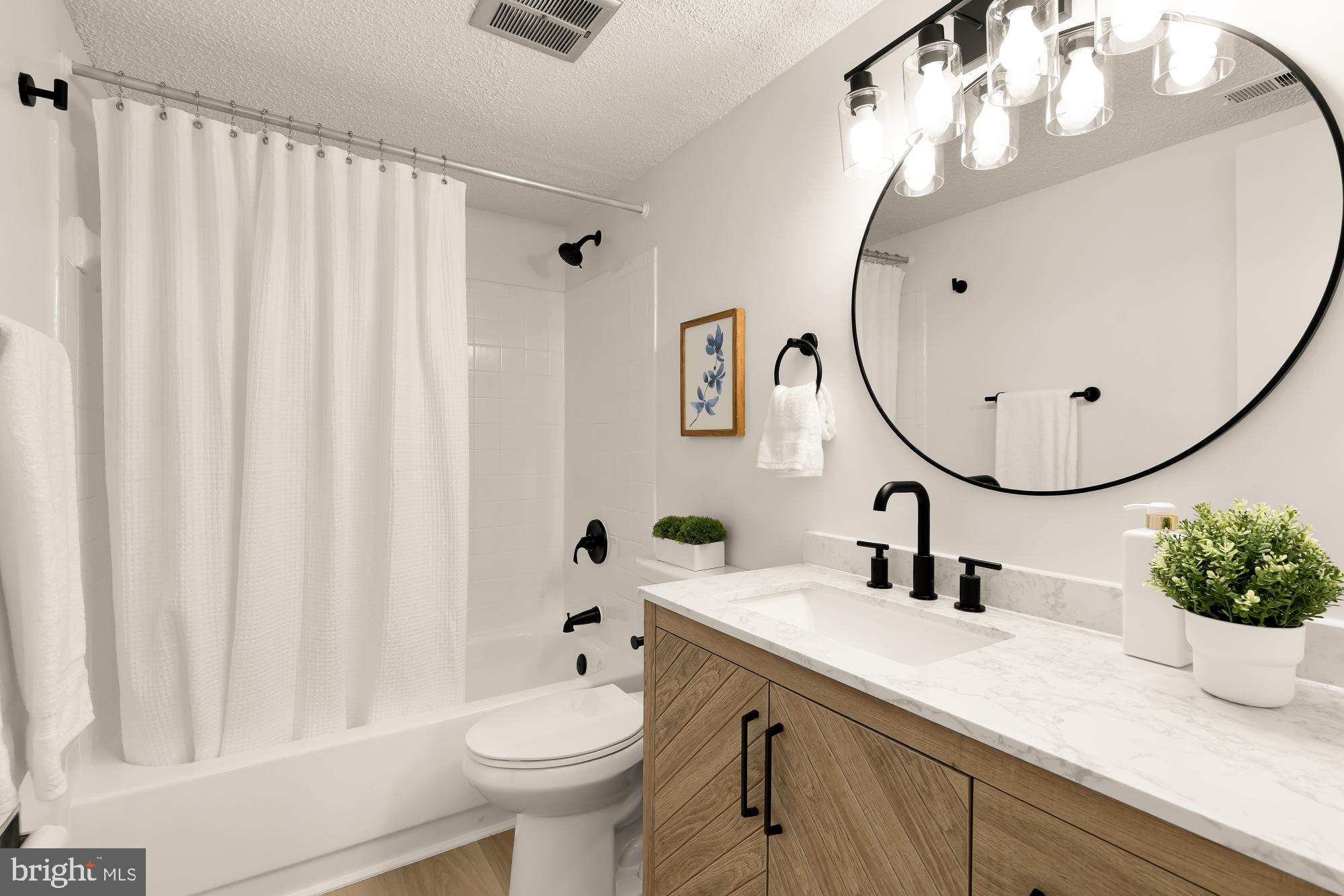 11833 Shire Court, Unit 21B Reston, VA 20191 - Photo 23 of 37 a bathroom with a sink toilet and mirror