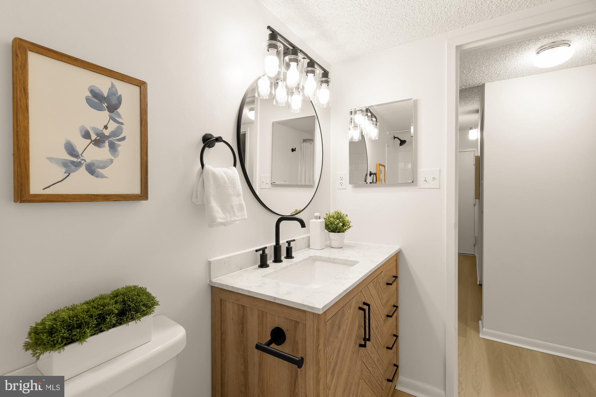 11833 Shire Court, Unit 21B Reston, VA 20191 - Photo 24 of 37 a bathroom with a sink and a mirror