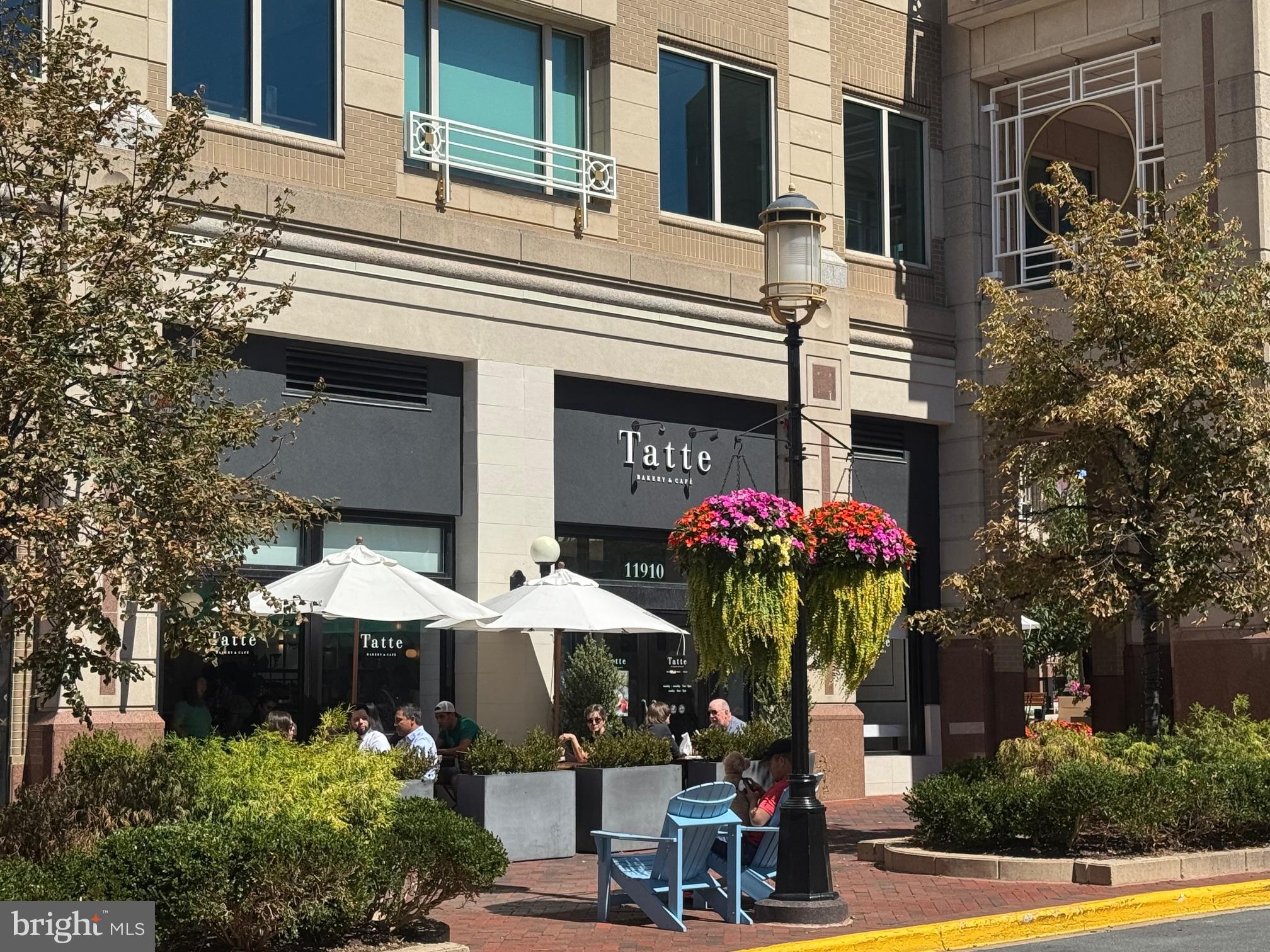 11833 Shire Court, Unit 21B Reston, VA 20191 - Photo 29 of 37 a front view of a house with yard and sitting area