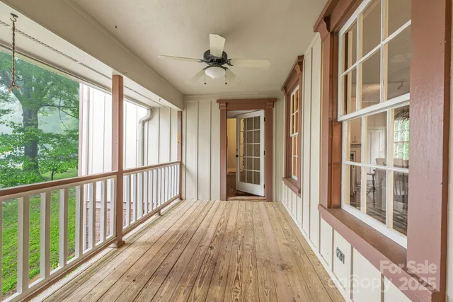 a view of room with window and wooden floor