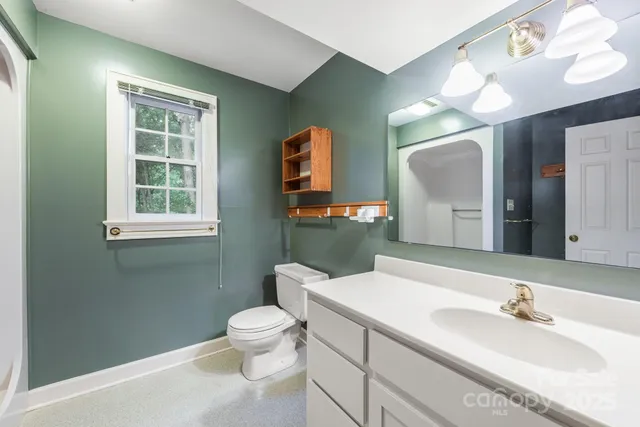 a front view of a house with a garden and trees