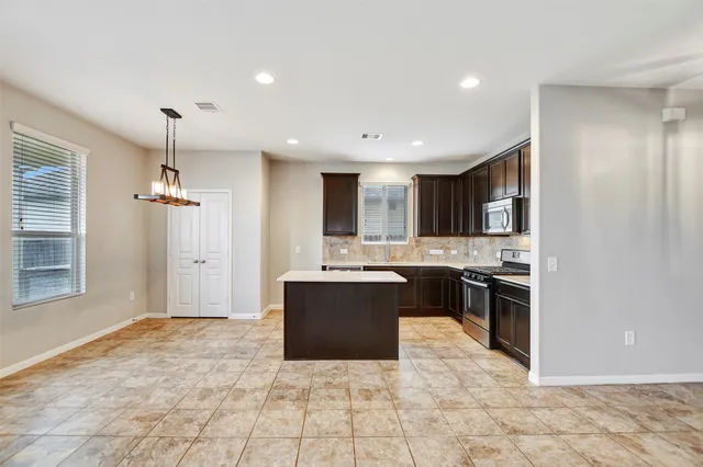 a kitchen with a sink stove and refrigerator