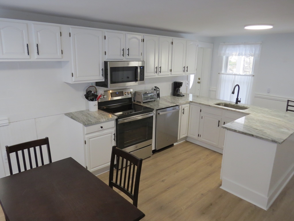 7 Maple Place Winchendon, MA 01475 - Photo 3 of 22 a kitchen with cabinets appliances a sink and a counter top space