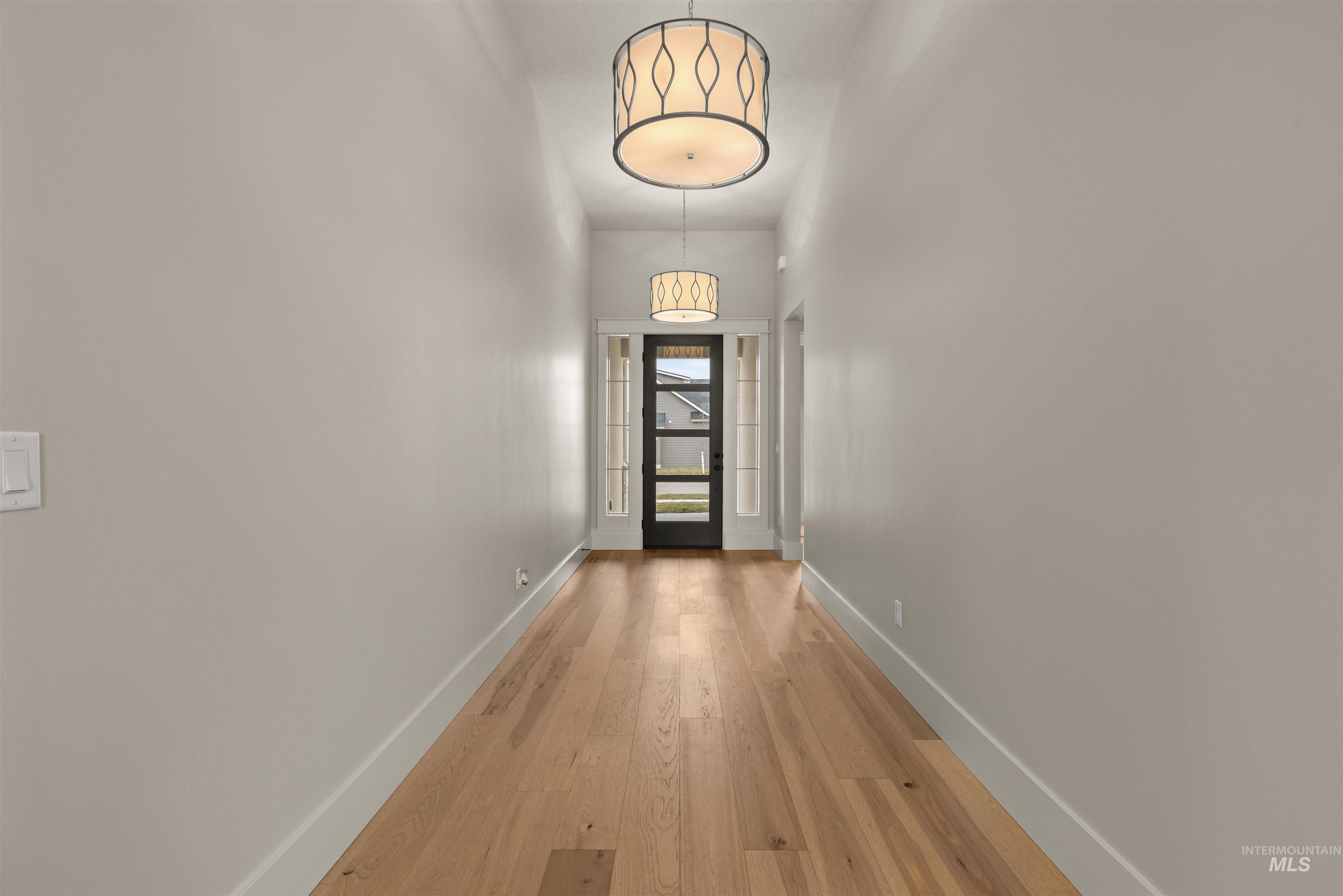6844 South Messner Way Meridian, ID 83642 - Photo 2 of 49 Doorway with wood-type flooring and baseboards